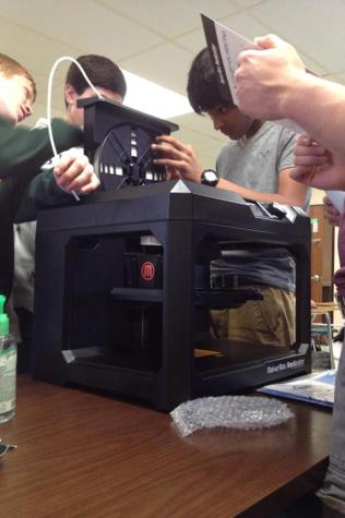 Cory Parsons engineering students experiment with the new 3D printer. 