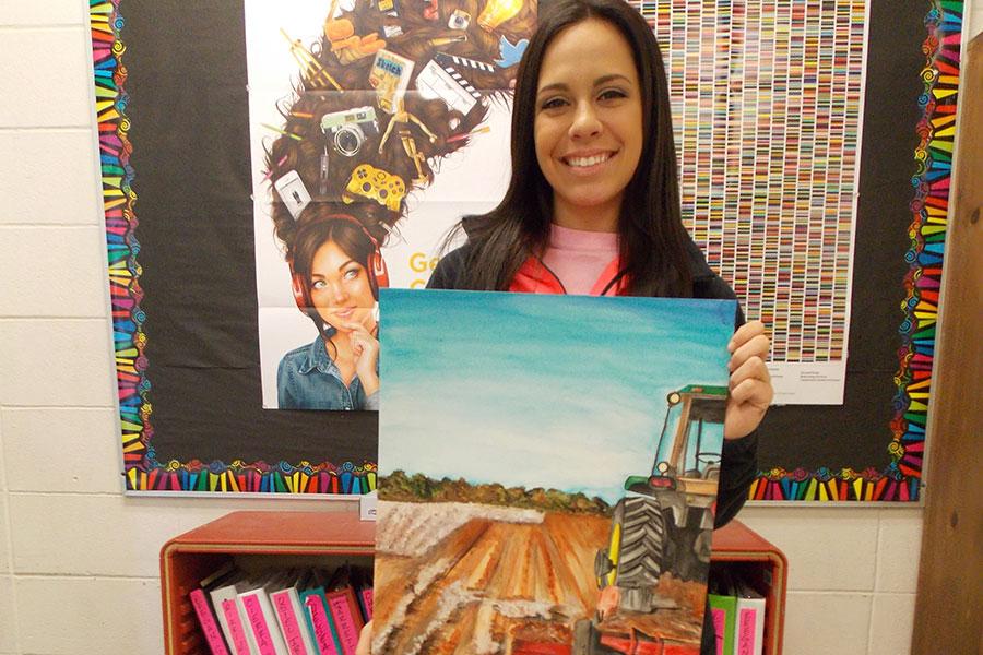 Senior art student Kirty Weatherly shows off her prize-winning painting, which won first place at the Houston Livestock Show and Rodeo. 