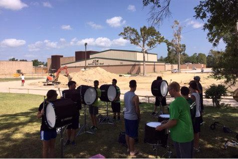 The Battlin Bear Band drumline makes adjustments to their practice as they watch the nearby construction.