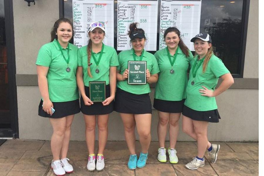The Lady Bear Golf team shows off another first place plaque. 