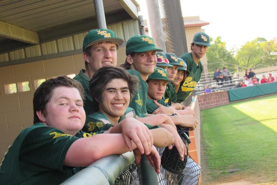 The sophomore baseball players cheer on their team. 