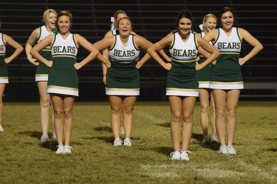 The varsity cheerleaders crack up after a funny skit. 