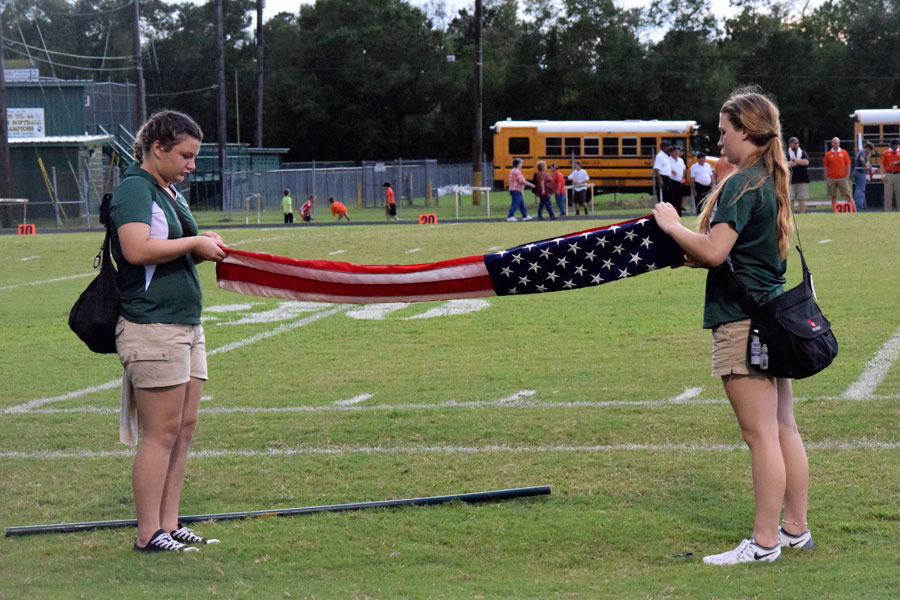 Trainers Justice Butler and Jacie Miller perfect folding the American flag. 