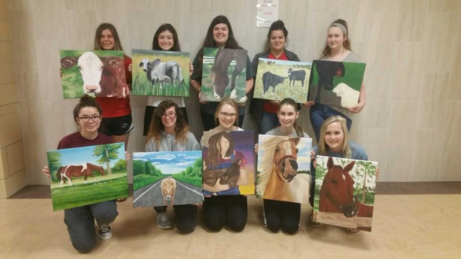 Students+show+off+their+pieces+that+were+selected+for+the+Houston+Livestock+Show+and+Rodeo+contest.+