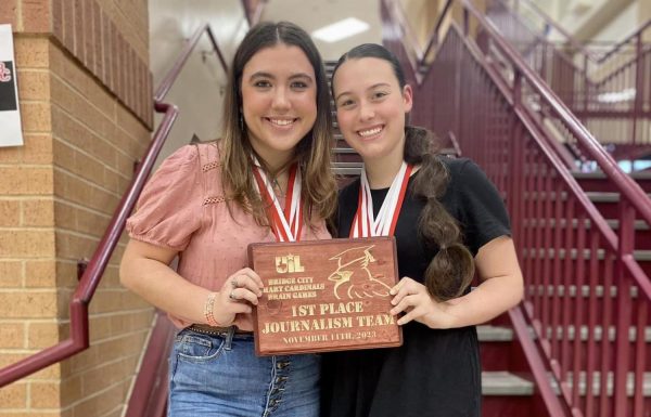 Journalism team members Rayna Christy and Gabrielle Moore show off their first place plaque. Not pictured is Camille Kelly. 