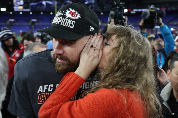 BALTIMORE, MARYLAND - JANUARY 28: Travis Kelce #87 of the Kansas City Chiefs celebrates with Taylor Swift as she whispers in his ear after a 17-10 victory against the Baltimore Ravens in the AFC Championship Game at M&T Bank Stadium on January 28, 2024 in Baltimore, Maryland. (Photo by Patrick Smith/Getty Images)