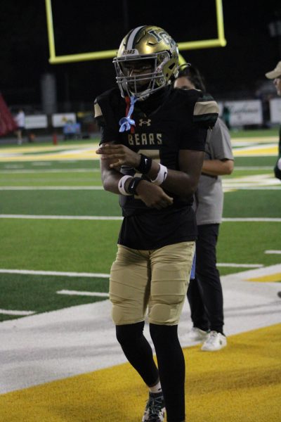 Braylon Lewis warms up on the sidelines during the home football game against Lumberton. 