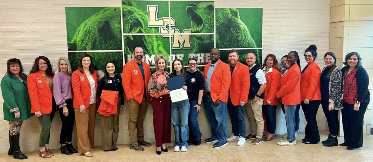Senior Bay Reynolds was presented with her award by members of the Greater Orange Area Chamber of Commerce.