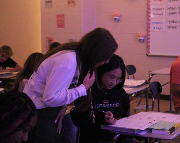 Spanish one and two teacher Jordyn Knighton helps a student with classwork.